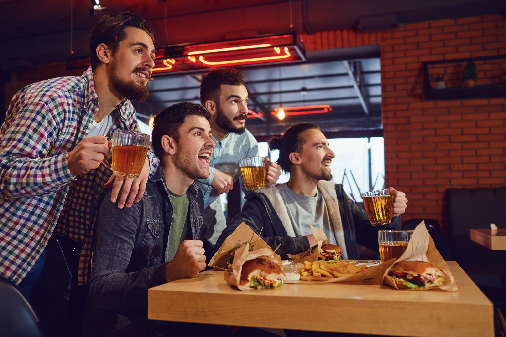Friends fans watch sport tv in the pub