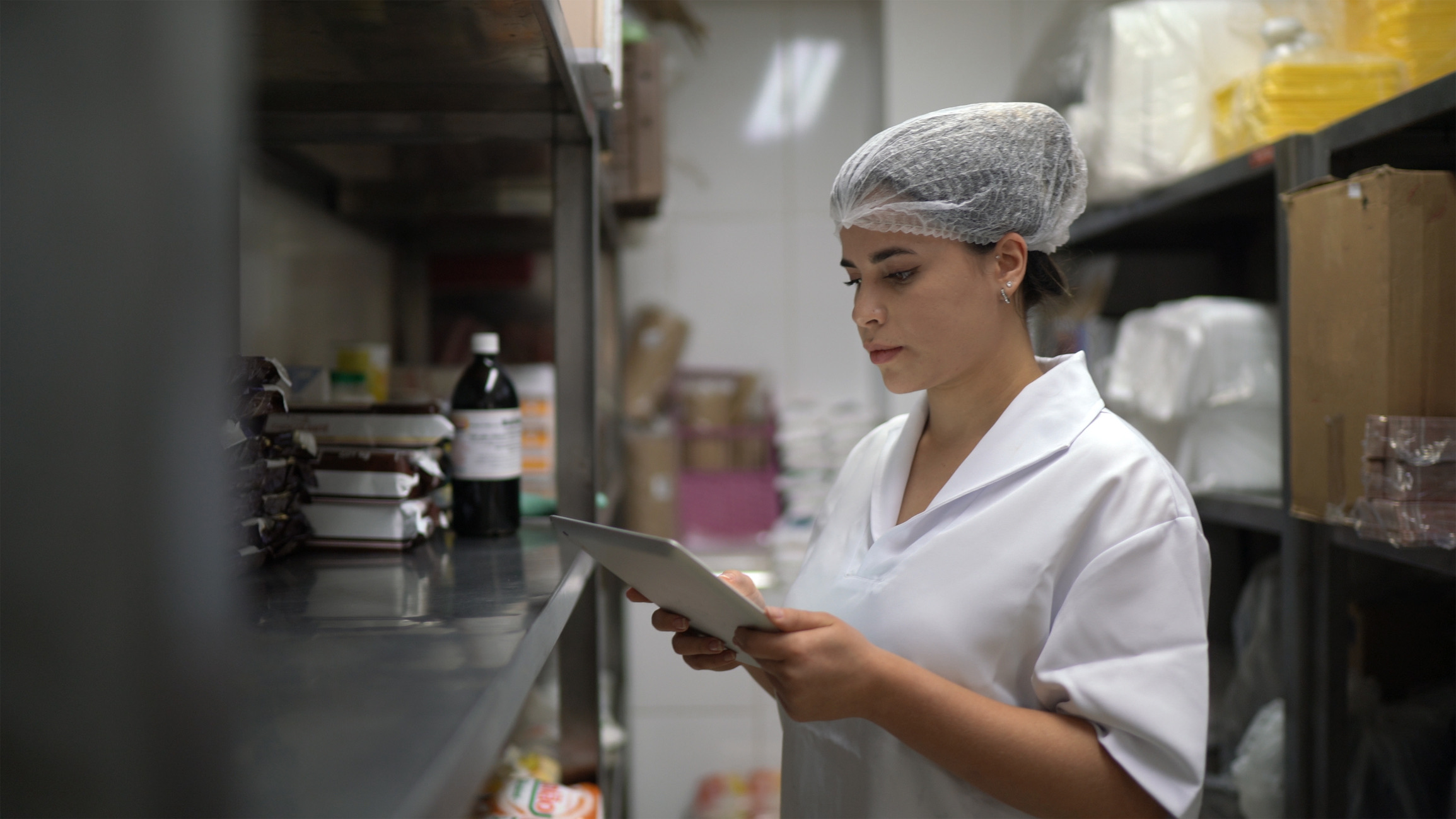 Employee checking storage room using digital tablet
